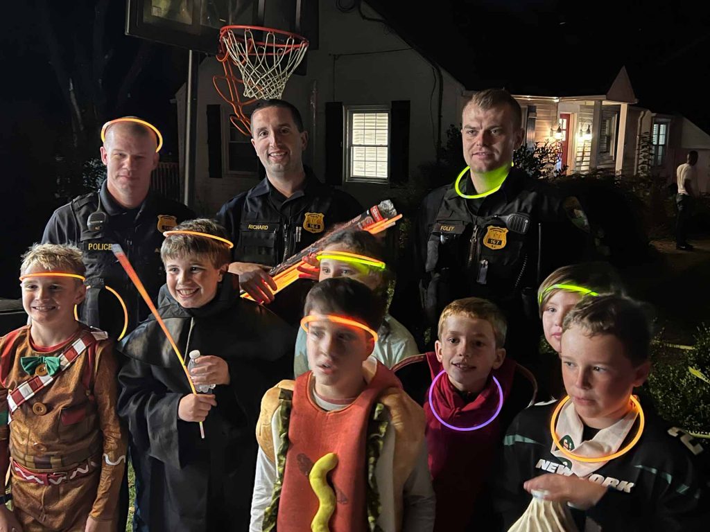 Three Bernardsville Law Enforcement officers posting with children on Halloween